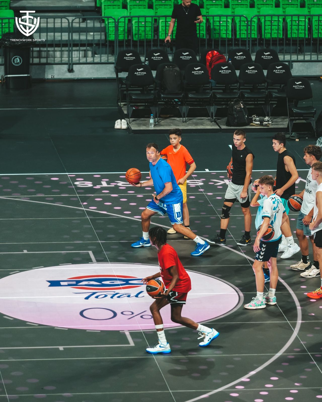 Tyler Relph coaching a group of young players on the court